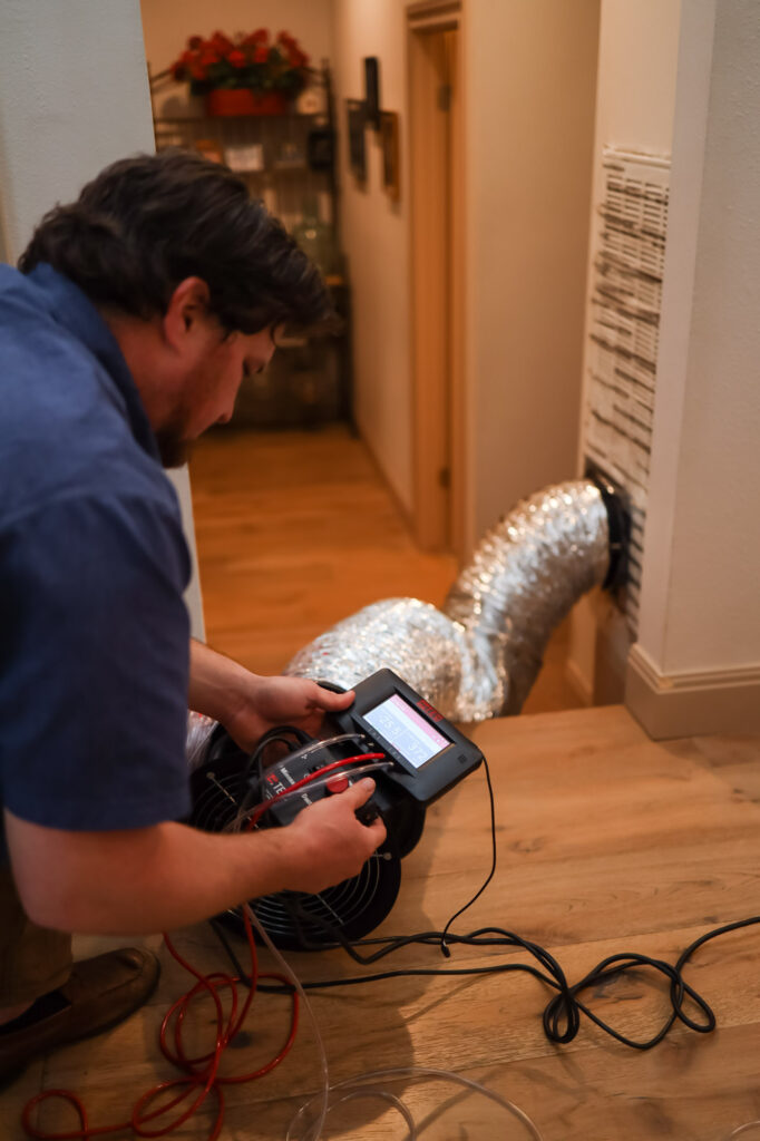 man performing duct leakage test